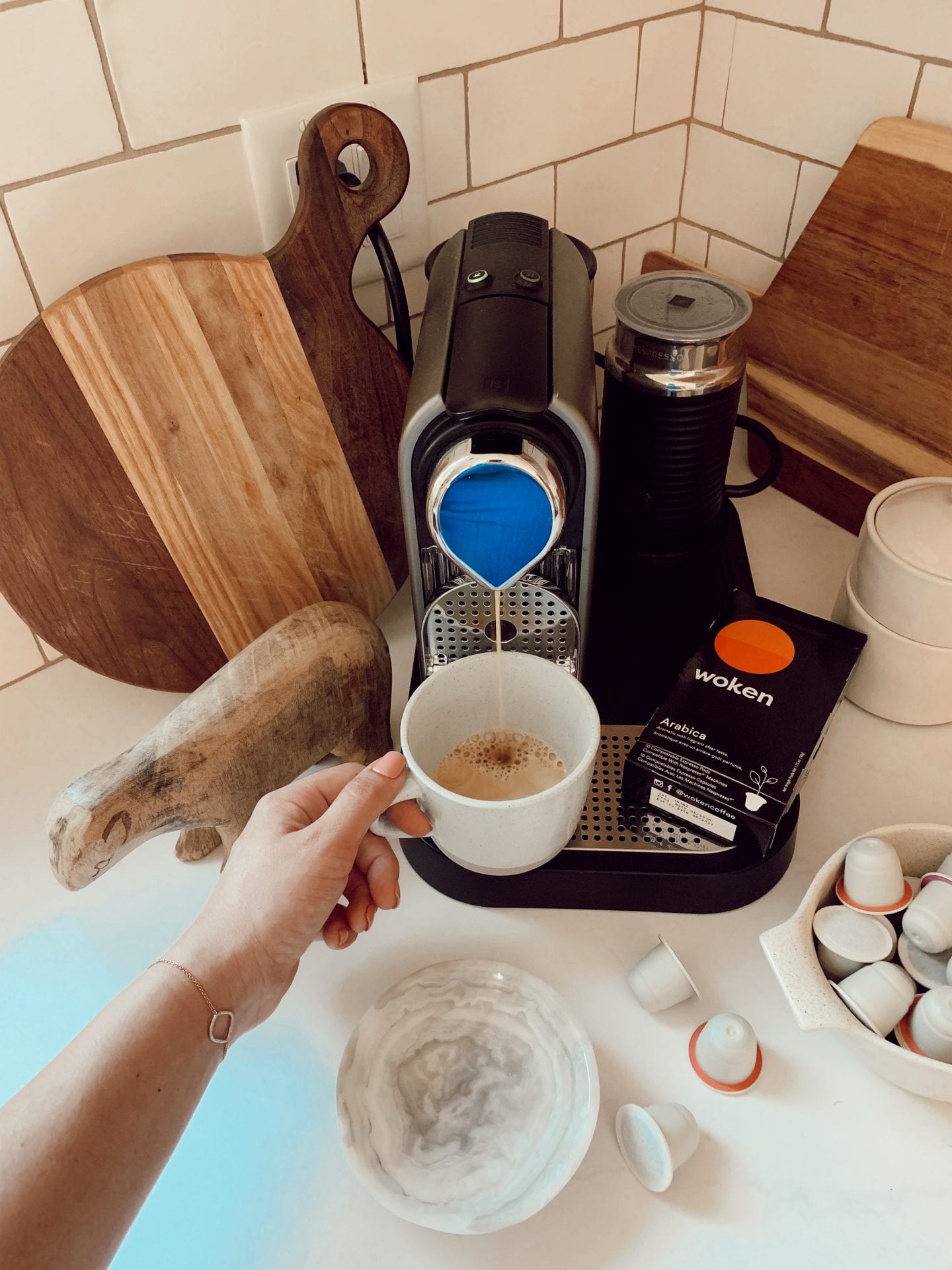 ditching starbucks habit | WHY I'M DITCHING MY STARBUCKS ADDICTION AND HOW YOU CAN TOO by popular San Francisco life and style blog, Just Add Glam: image of a woman using an at home espresso machine. 